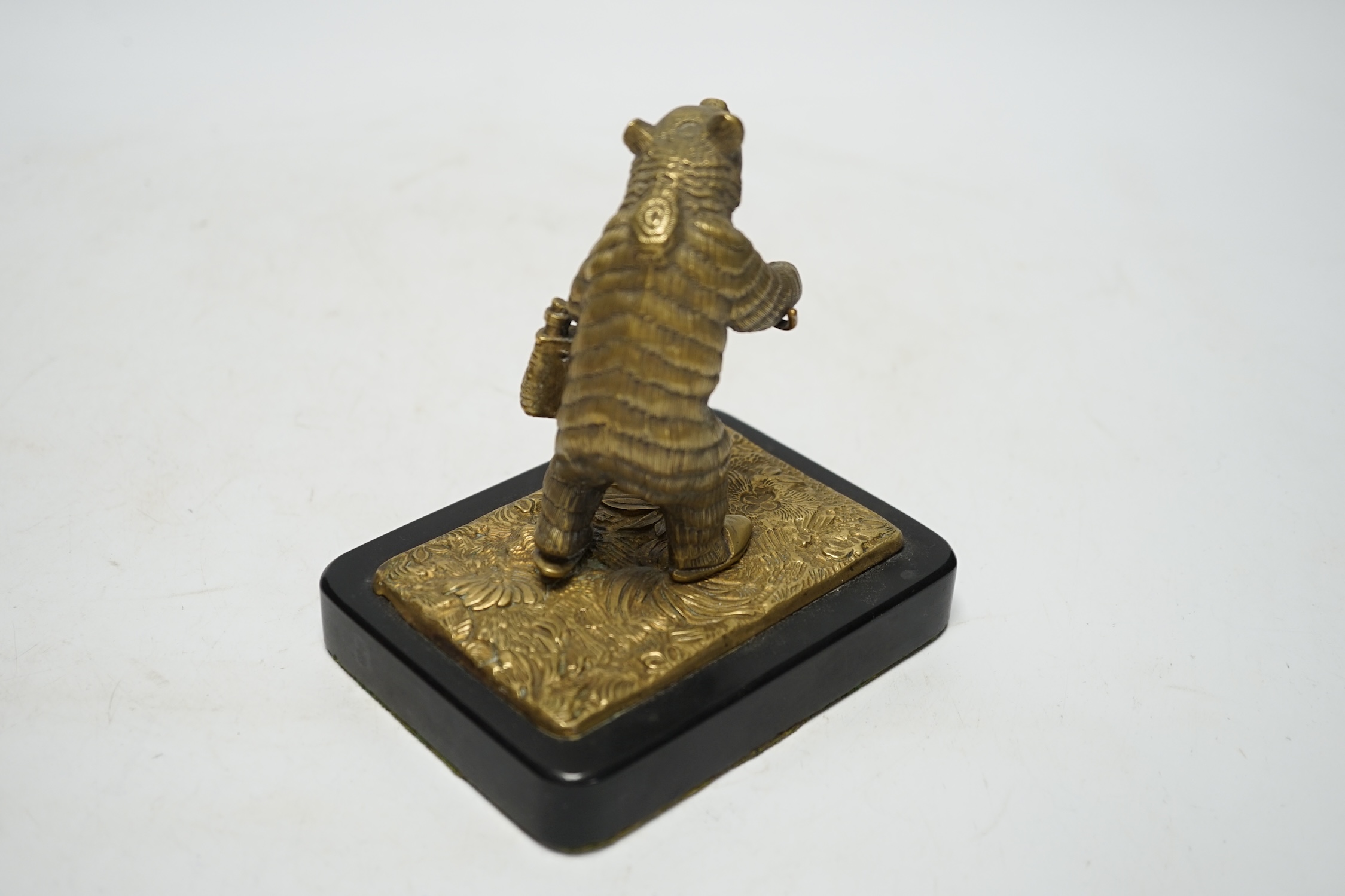 A novelty bronze bear paperweight on stand, 12.5cm high